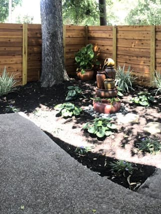 Shaded courtyard with wooden fence