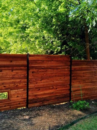 Horizontal wood fence with black posts