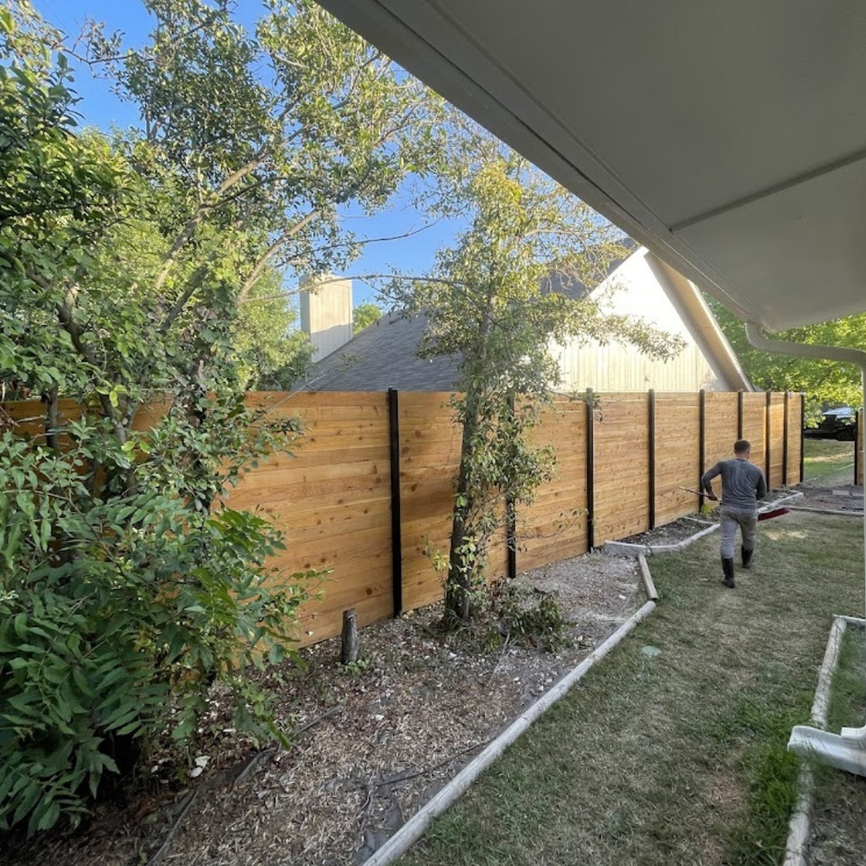 Horizontal wood, privacy fence with light wood and dark posts